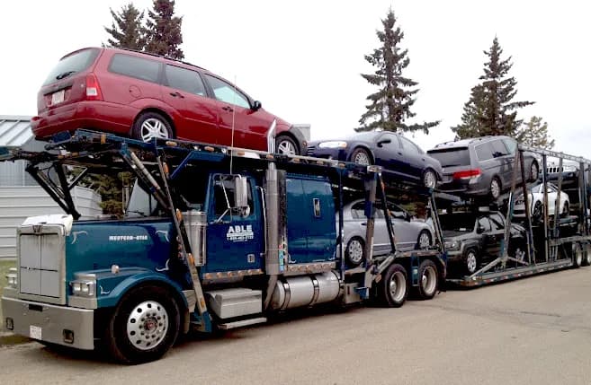 An Able Auto Transport car carrier loaded with vehicles on its upper and lower decks