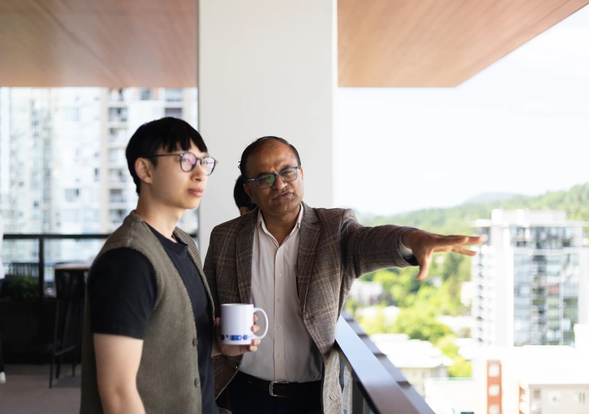 Two team members collaborating on a balcony.