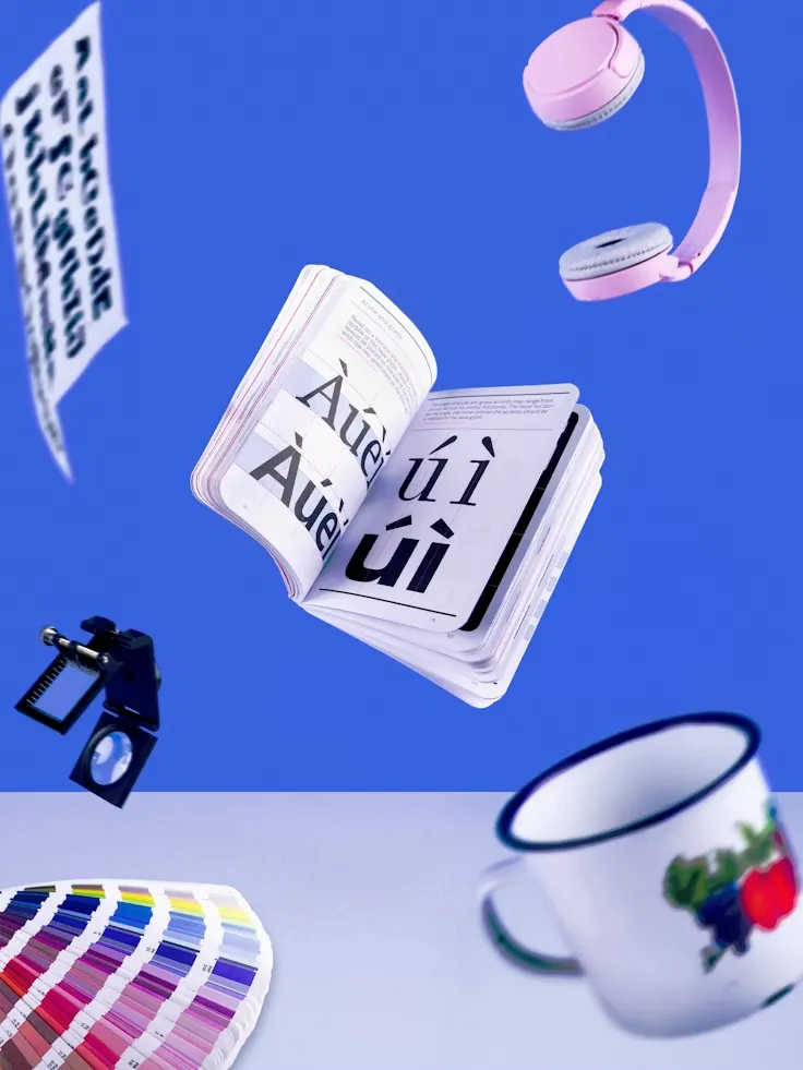 A vivid type-and-object composition on a blue backdrop.