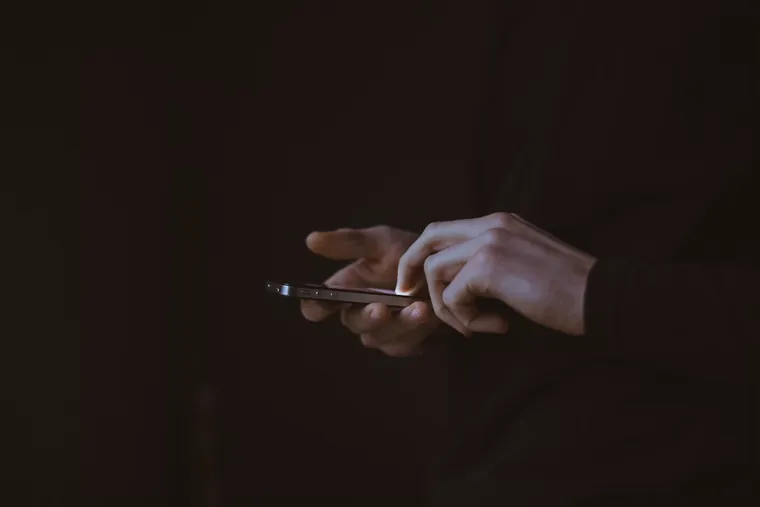 A hand in low light.